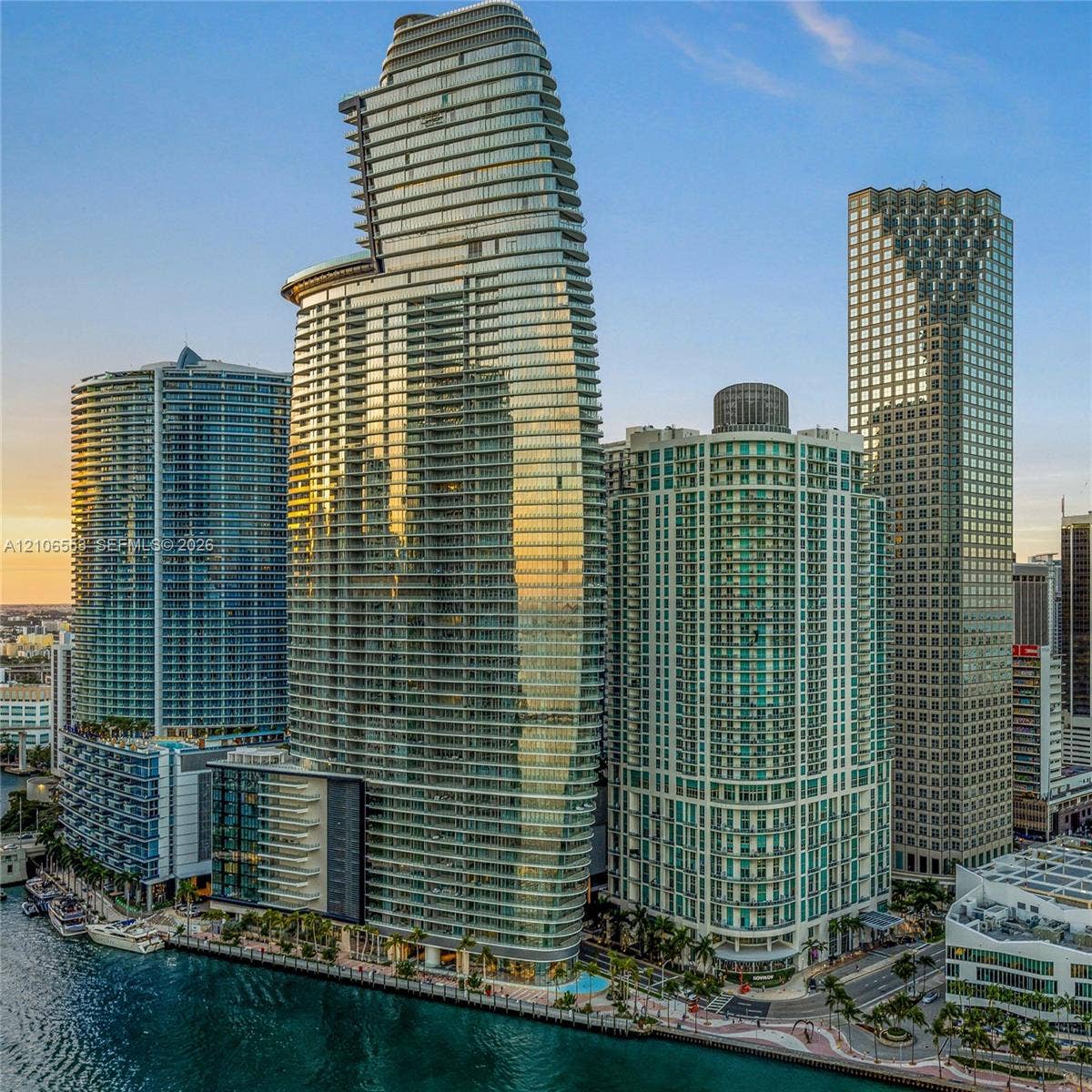 300 Biscayne Boulevard Way, #3002E, Miami, FL 33131 High-rise residential tower featuring a glass-curtain facade, wrap-around balconies, and waterfront positioning