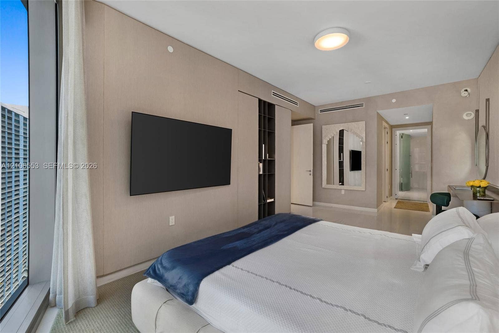300 Biscayne Boulevard Way, #3002E, Miami, FL 33131 Floor-to-ceiling windows, wall-to-wall integrated paneling, built-in vertical shelving, recessed lighting, and mirrored wall accents