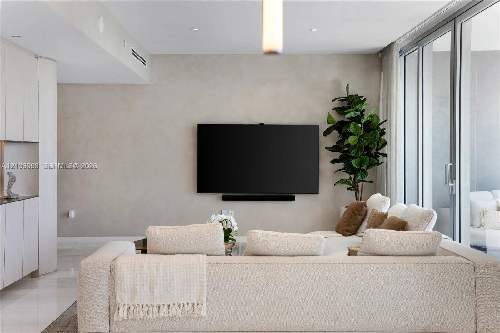 300 Biscayne Boulevard Way, #3002E, Miami, FL 33131 Living area featuring smooth-finish walls, floor-to-ceiling sliding glass doors, polished stone flooring, and recessed ceiling lighting