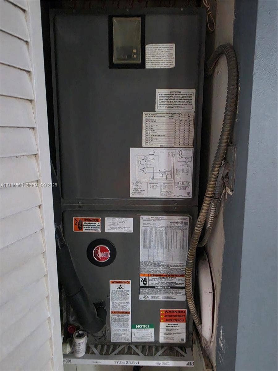 9550 W Elm Lane, Miramar, FL 33025 Rheem HVAC system featuring an integrated metallic cabinet, diagnostic information placards, and accessible air filtration housing