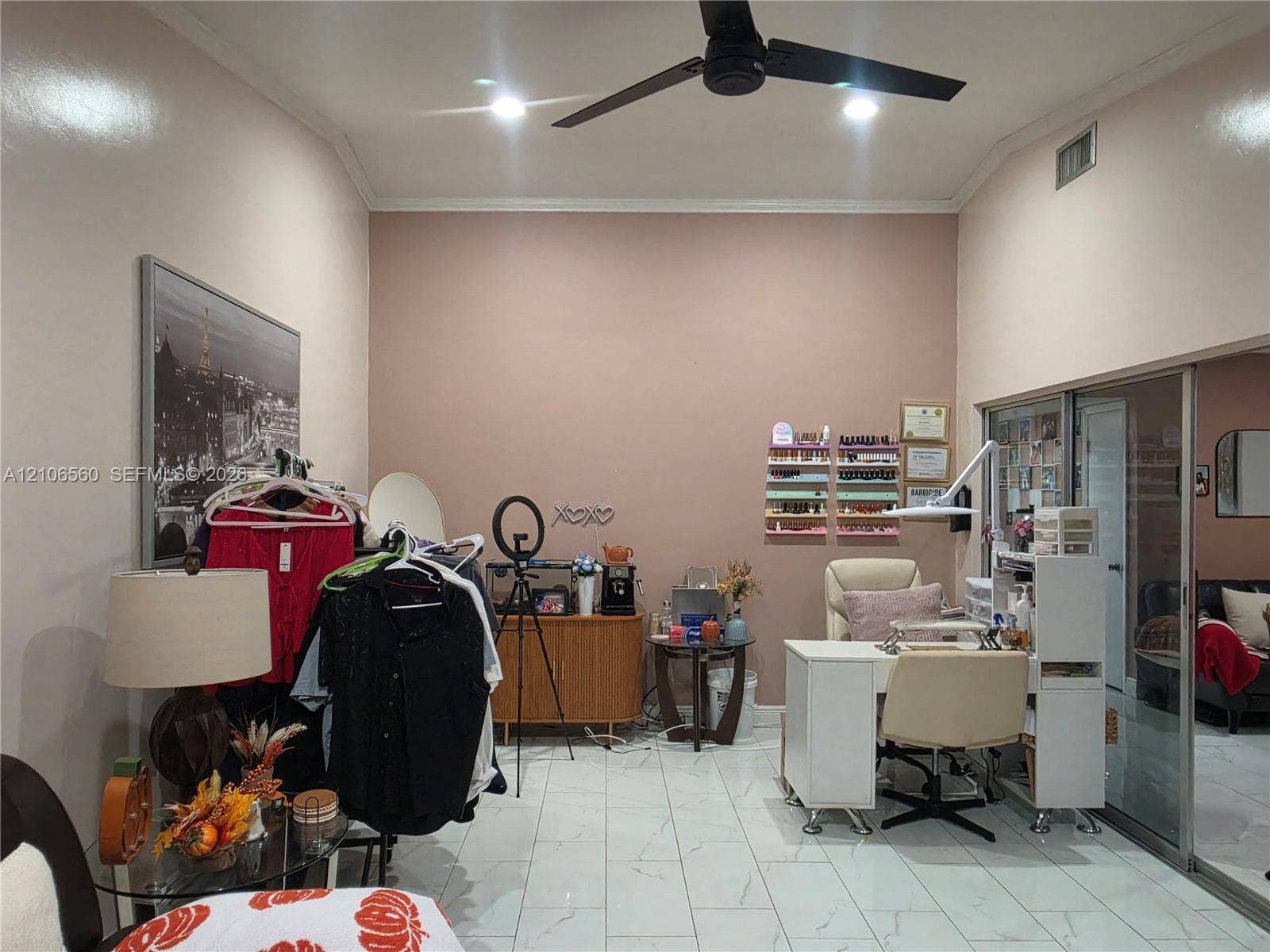 9550 W Elm Lane, Miramar, FL 33025 Room featuring high vaulted ceilings, large-format tile flooring, a matte black ceiling fan, and sliding glass entry doors