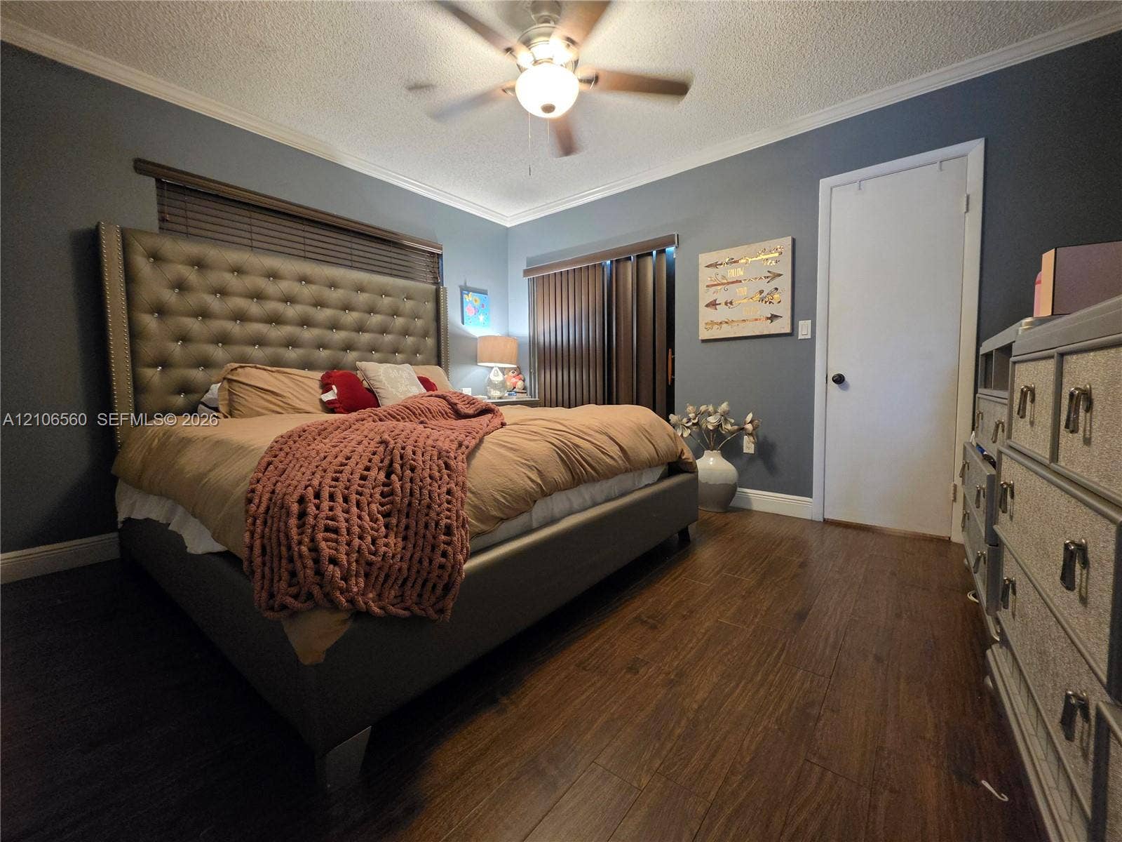 9550 W Elm Lane, Miramar, FL 33025 Wood-finish flooring, ceiling fan with integrated lighting, and vertical window blinds