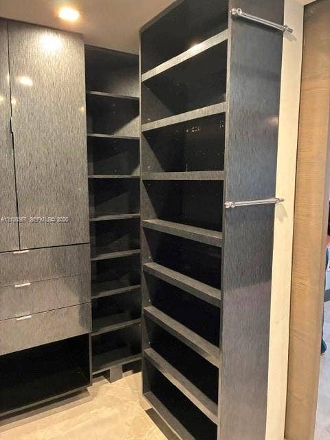 Custom dark-finish cabinetry featuring multi-level open shelving, integrated storage drawers, and polished chrome hardware accents