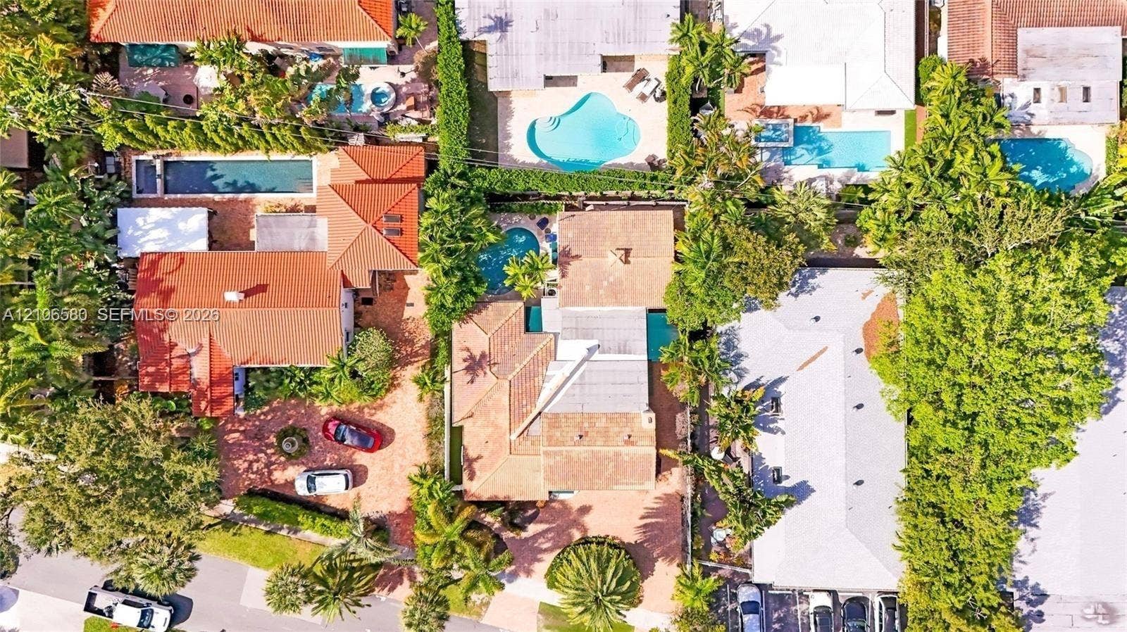 623 NE 17th Way, Fort Lauderdale, Fort Lauderdale, FL 33304 Aerial view of the property featuring a tile roof, an in-ground swimming pool, and a paved driveway