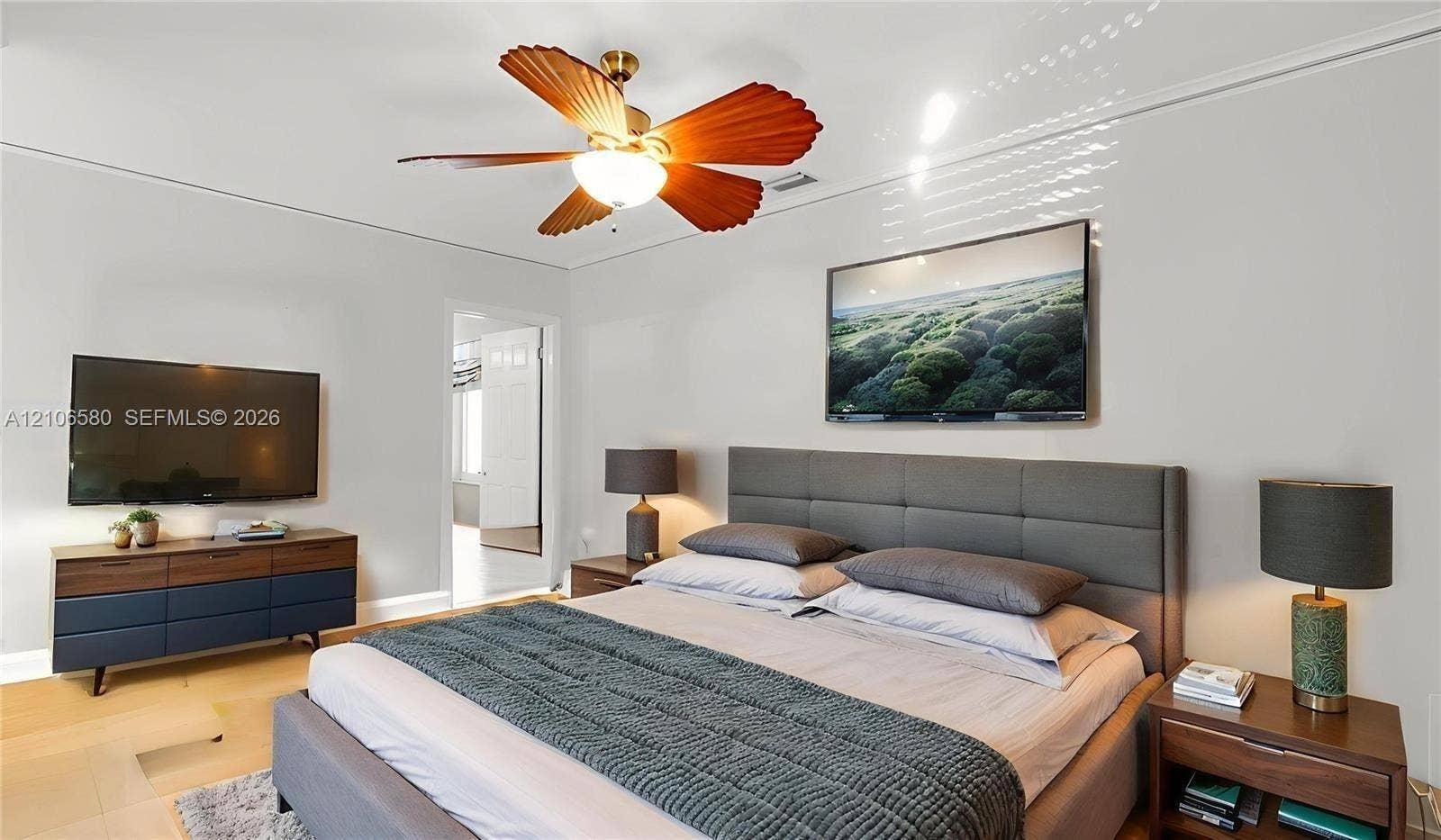 623 NE 17th Way, Fort Lauderdale, Fort Lauderdale, FL 33304 Spacious room featuring wood-finish flooring and a central ceiling fan with leaf-shaped blades