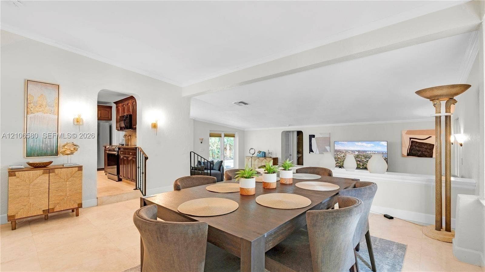 623 NE 17th Way, Fort Lauderdale, Fort Lauderdale, FL 33304 Open-concept interior featuring neutral tile flooring, recessed lighting, crown molding, arched entryways, and wall-mounted sconce lighting
