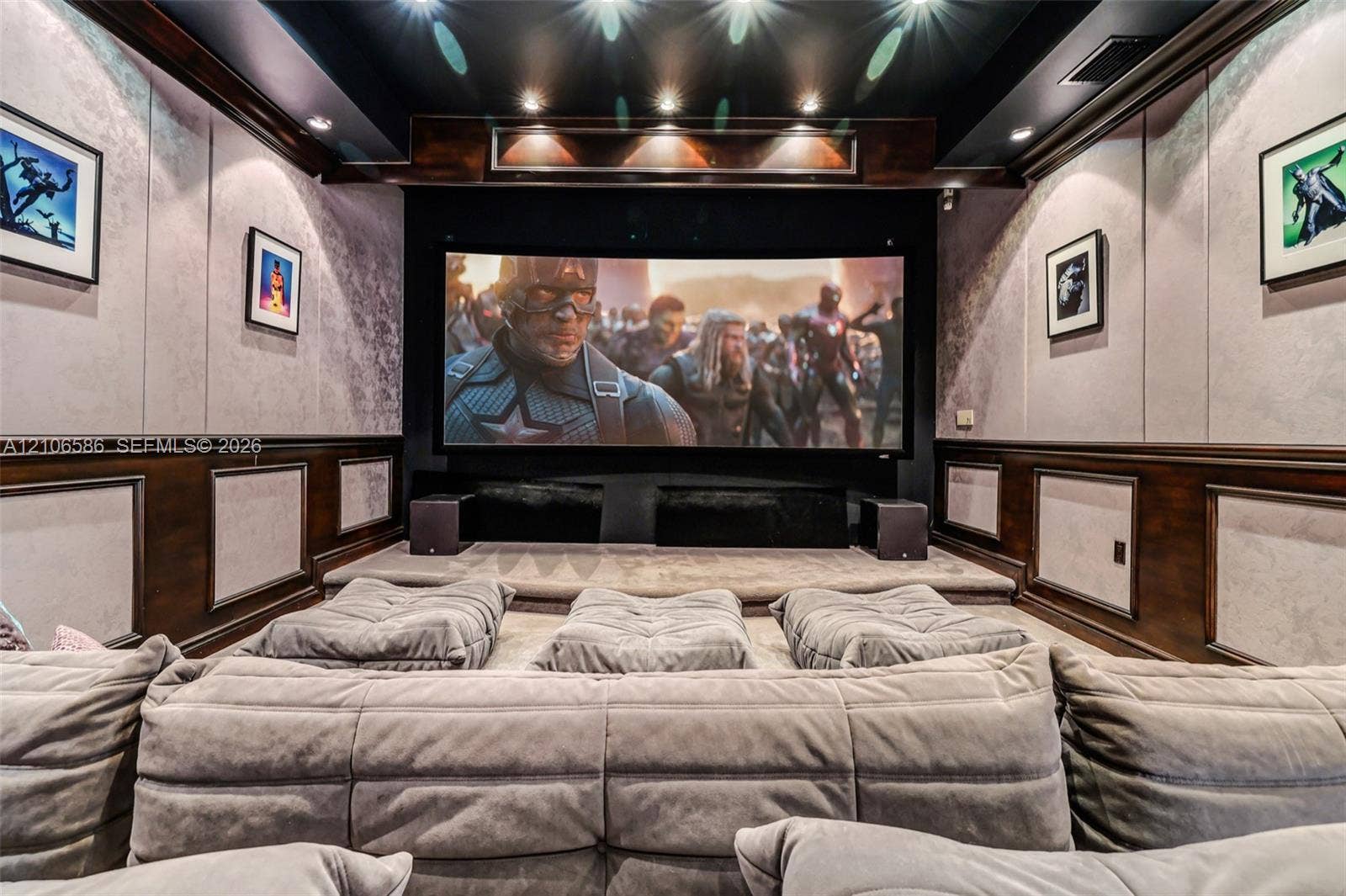 9325 SW 59th Place, Pinecrest, FL 33156 Dedicated screening room featuring a tiered floor, custom wood wainscoting, recessed ceiling lighting, and integrated wall paneling