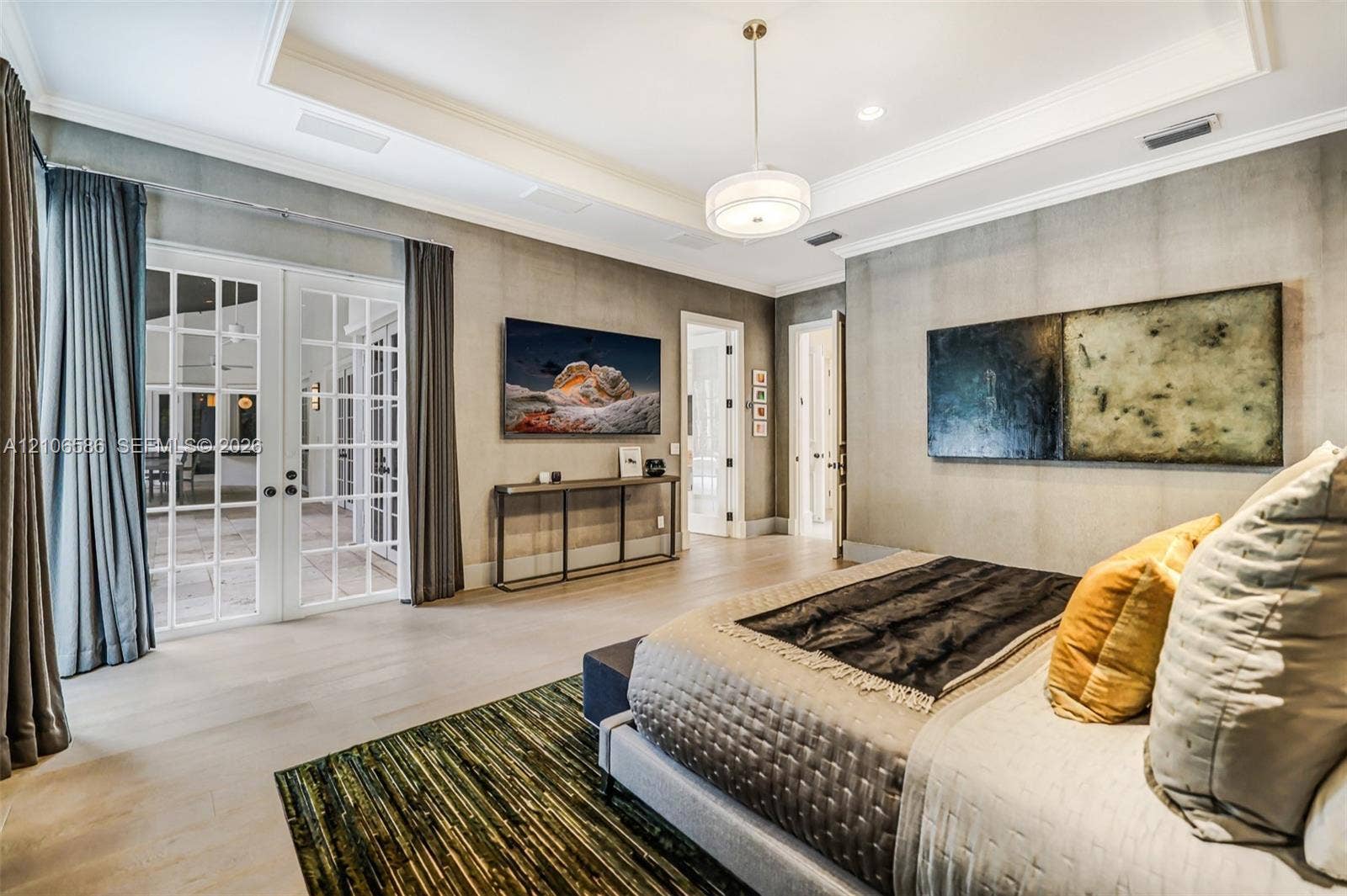 9325 SW 59th Place, Pinecrest, FL 33156 Tray ceiling with crown molding, double French doors with glass panes, wood-finish flooring, and recessed lighting
