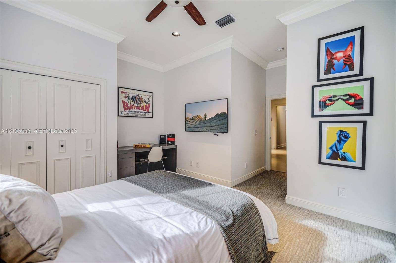 9325 SW 59th Place, Pinecrest, FL 33156 Neutral-toned bedroom featuring recessed lighting, a ceiling fan, carpeted flooring, crown molding, and a built-in desk with cabinetry