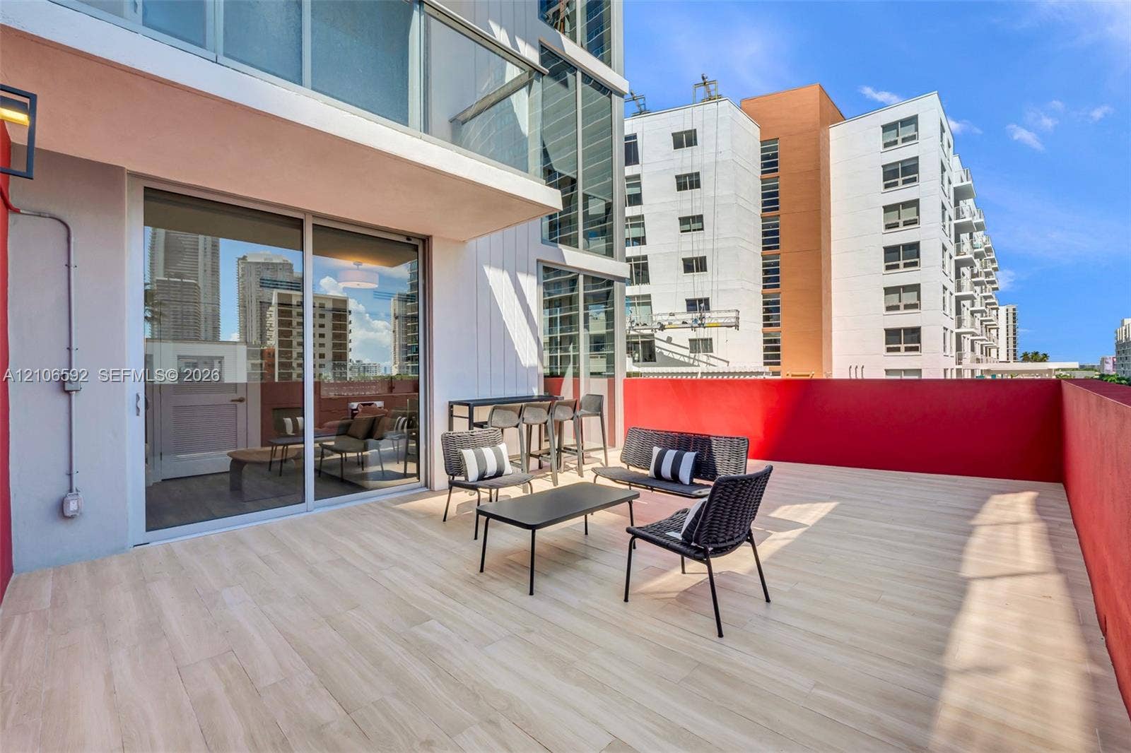 90 NE 32, #612, Miami, Miami, FL 33127 Expansive private terrace featuring wood-finish tile flooring, a solid perimeter wall, and floor-to-ceiling glass sliding doors