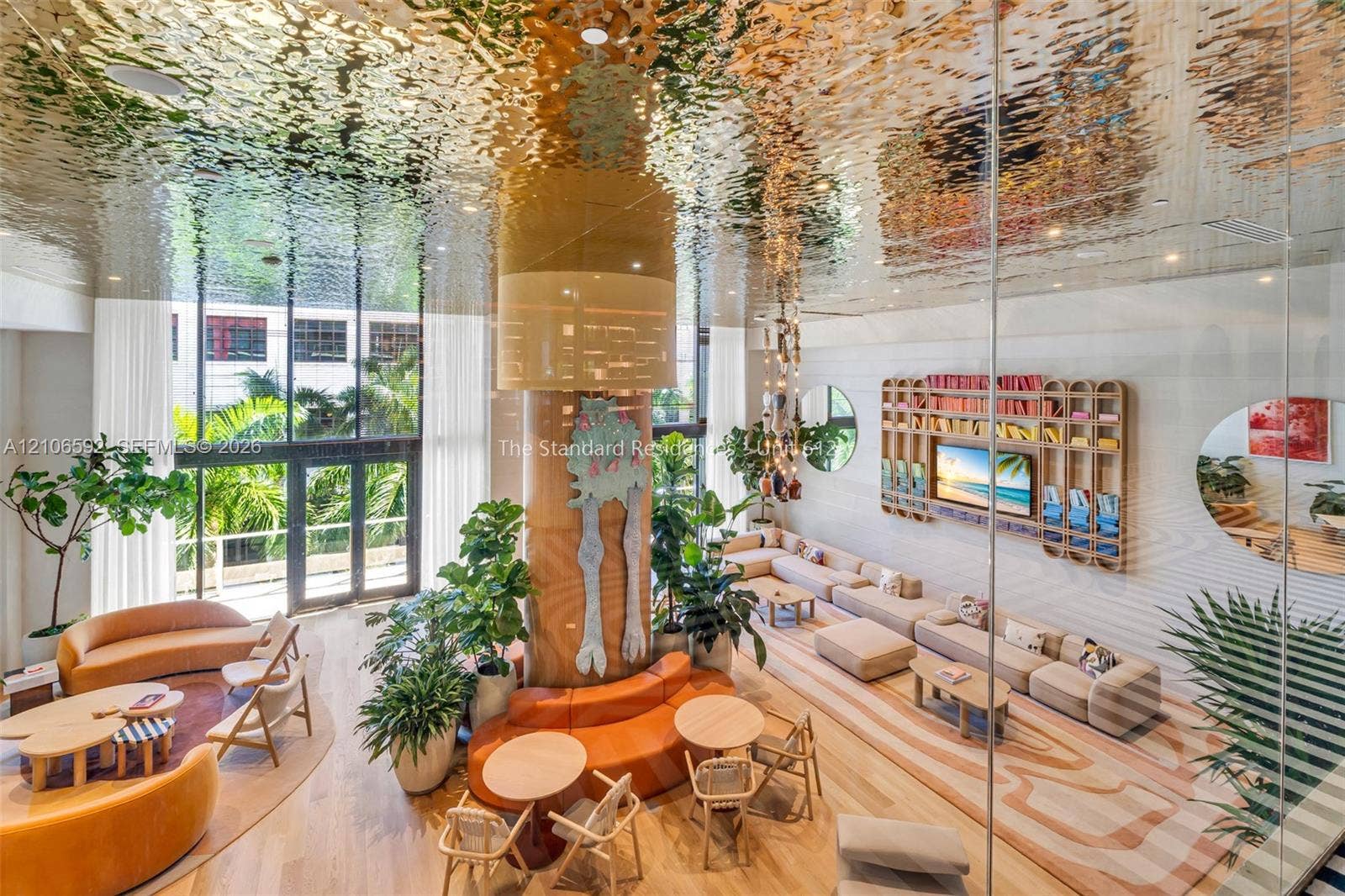 90 NE 32, #612, Miami, Miami, FL 33127 Common area featuring a reflective, textured metallic ceiling, floor-to-ceiling glass windows, wood-finish flooring, and a large custom built-in wall unit