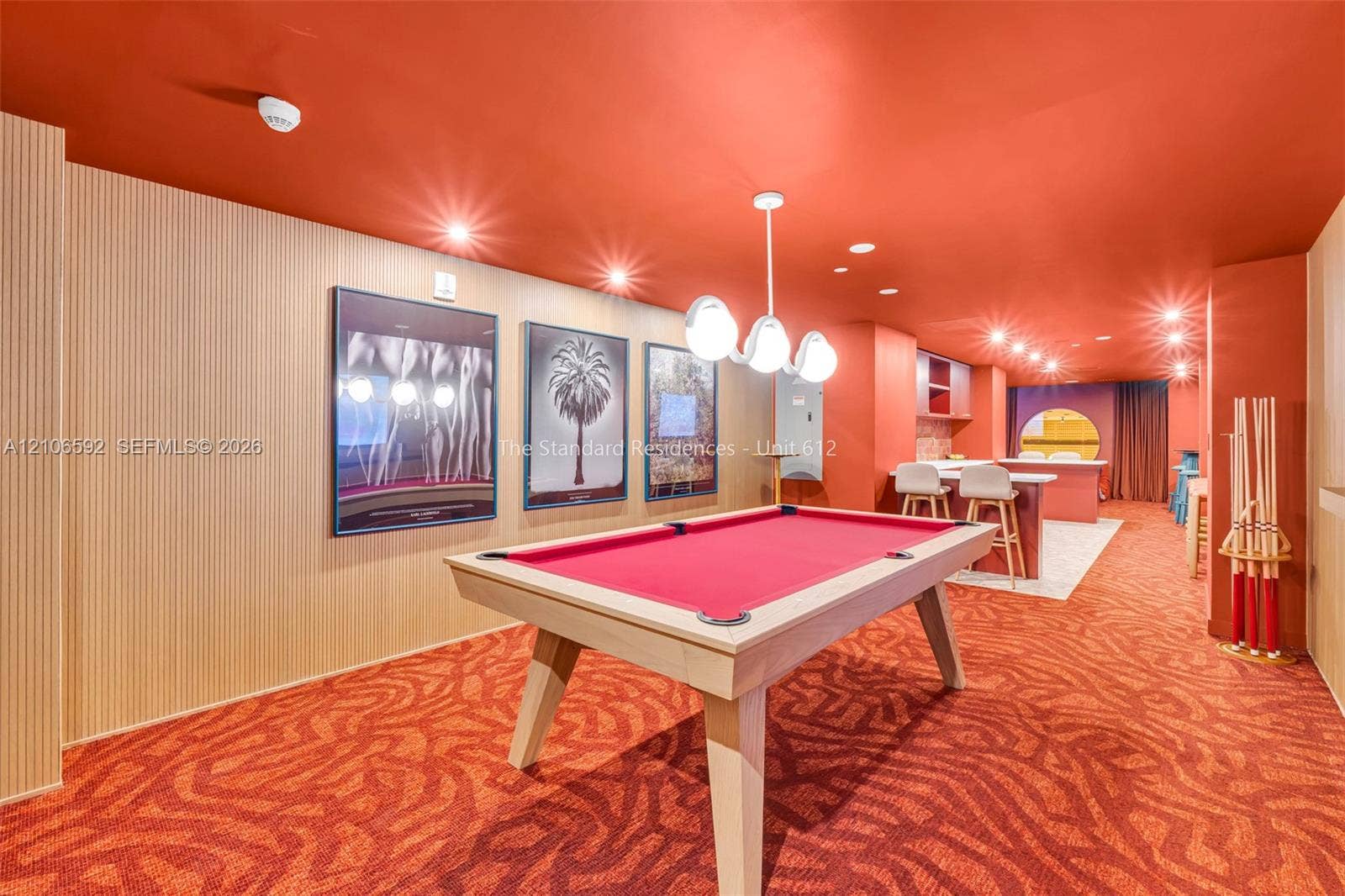 90 NE 32, #612, Miami, Miami, FL 33127 Textured light-wood paneling, integrated recessed ceiling lighting, contemporary multi-globe pendant light, and built-in service bar