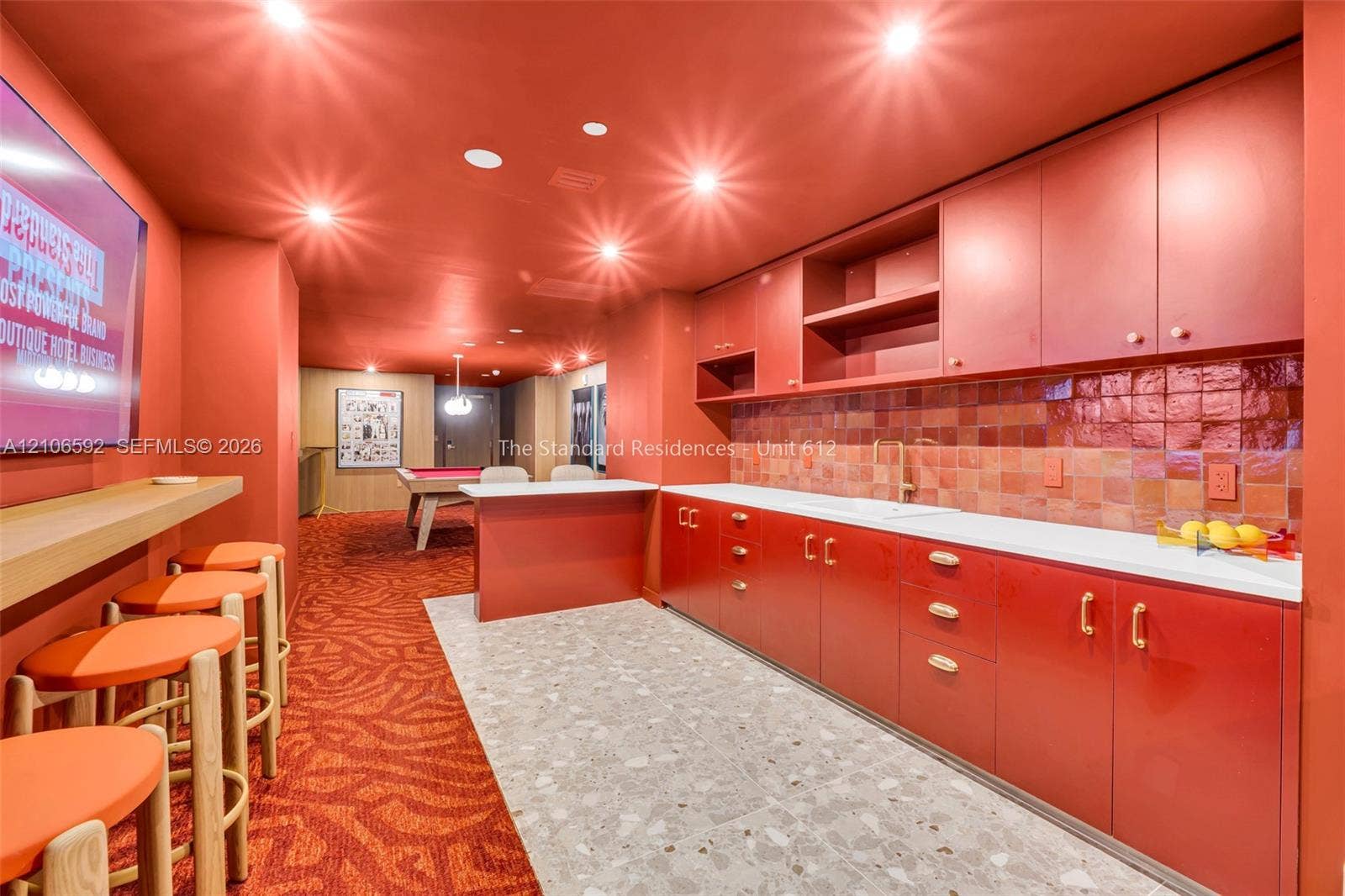 90 NE 32, #612, Miami, Miami, FL 33127 Custom cabinetry with flat-panel doors, high-gloss finish, metallic hardware, and terra-cotta tile backsplash, complemented by a light-toned terrazzo-style floor