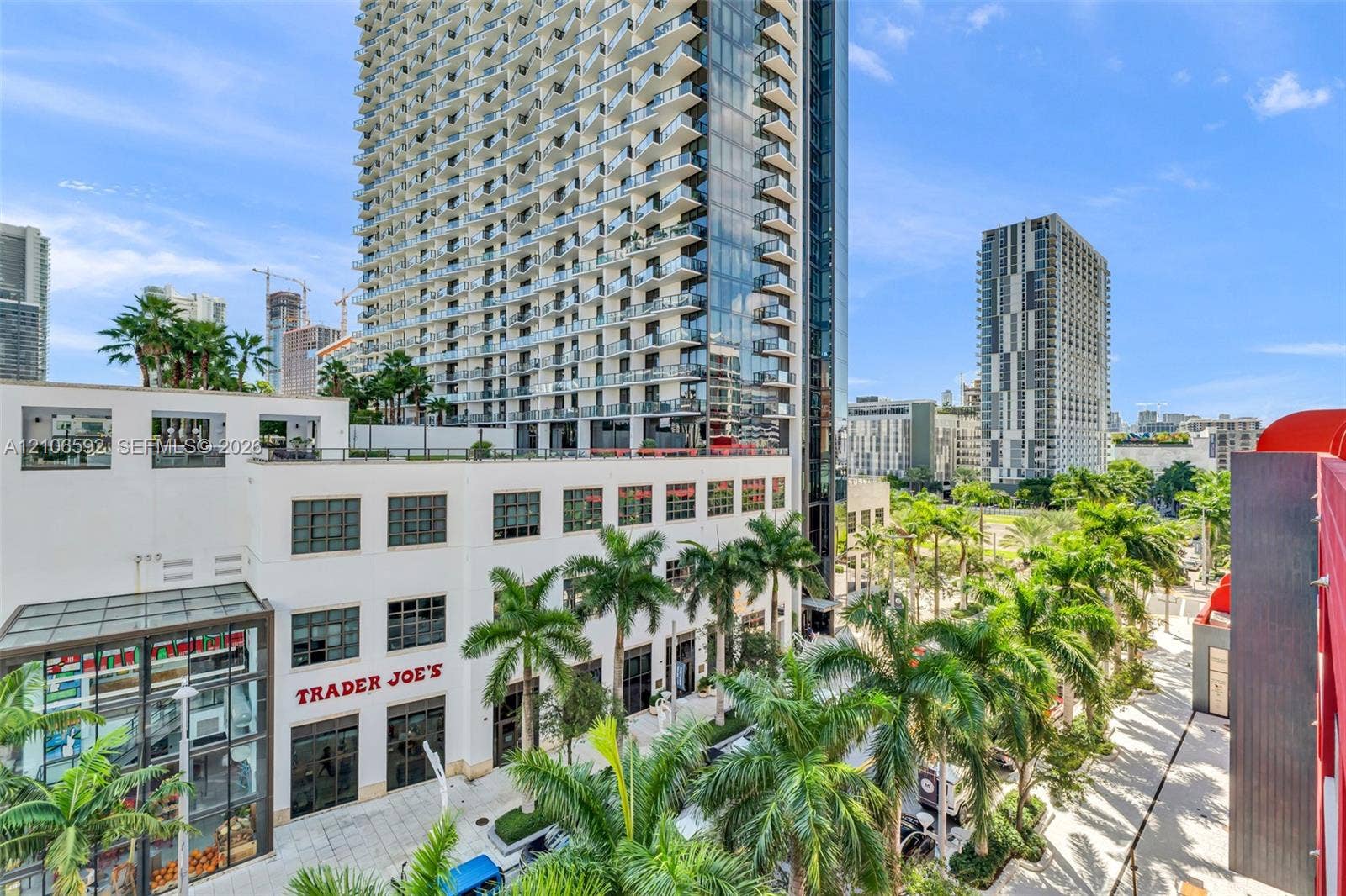 90 NE 32, #612, Miami, Miami, FL 33127 High-rise architecture featuring extensive glass curtain walls, private balconies, a multi-story podium structure, and landscaped grounds with mature palm trees
