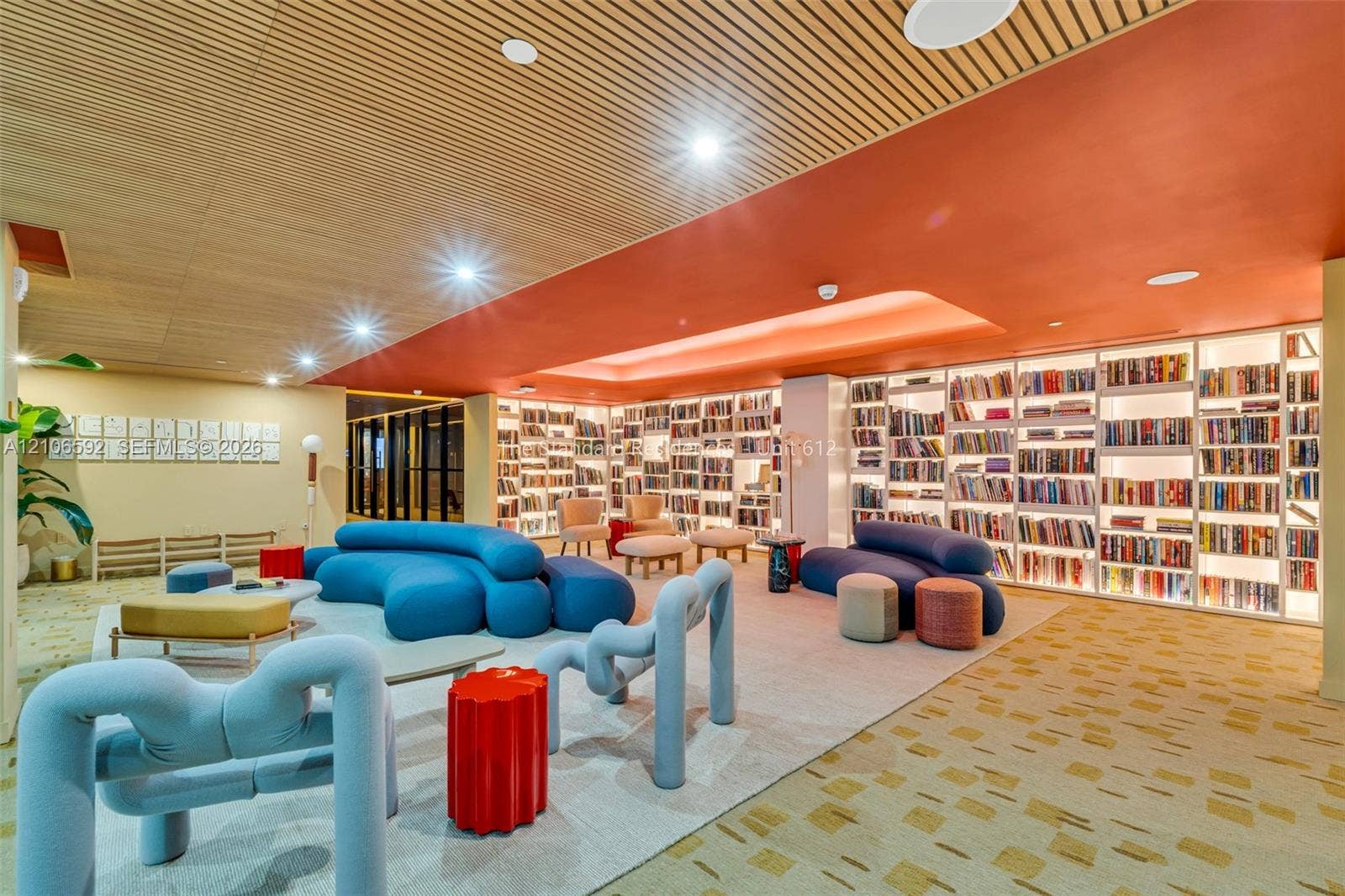 90 NE 32, #612, Miami, Miami, FL 33127 Custom floor-to-ceiling built-in shelving, slatted wood-finish ceiling, recessed lighting, and patterned carpeting