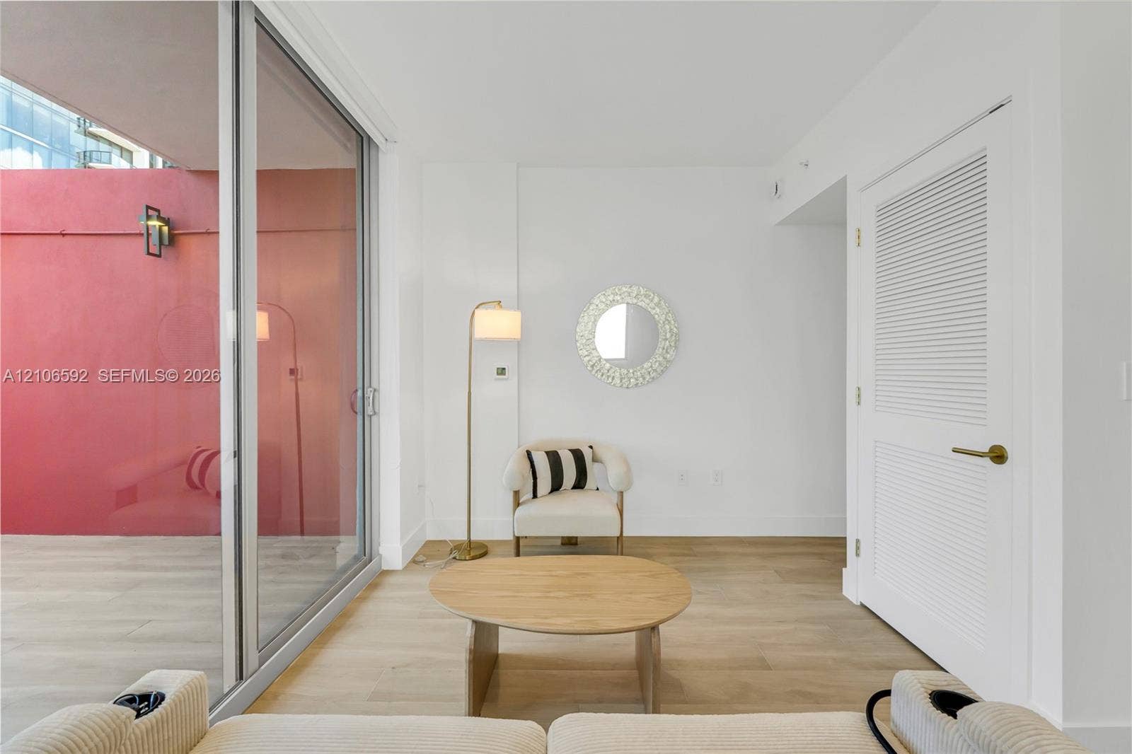 90 NE 32, #612, Miami, Miami, FL 33127 Floor-to-ceiling sliding glass door, wood-finish flooring, and white louvered door