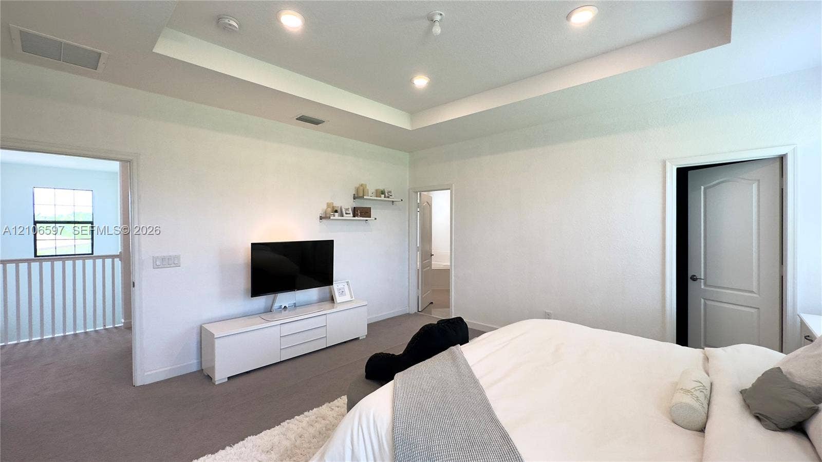 Tray ceiling featuring recessed lighting and wall-to-wall carpeting