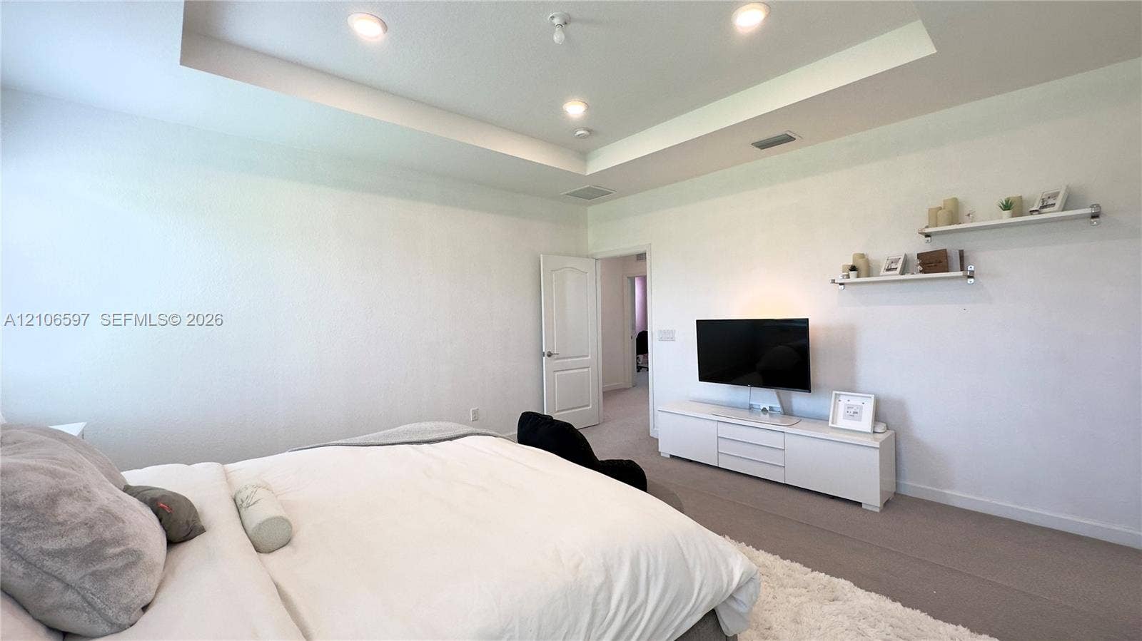 Tray ceiling, recessed lighting, and wall-mounted shelving