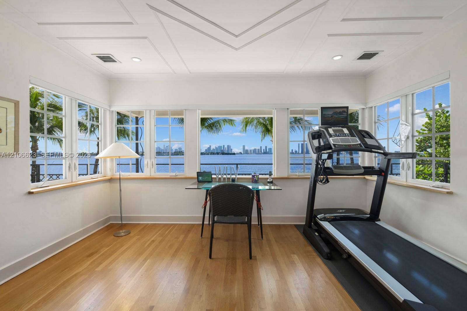 2312 Bay Avenue, Miami Beach, FL 33140 Multi-pane windows, wood-finish flooring, recessed lighting, and geometric coffered ceiling detail, with expansive water and skyline exposure