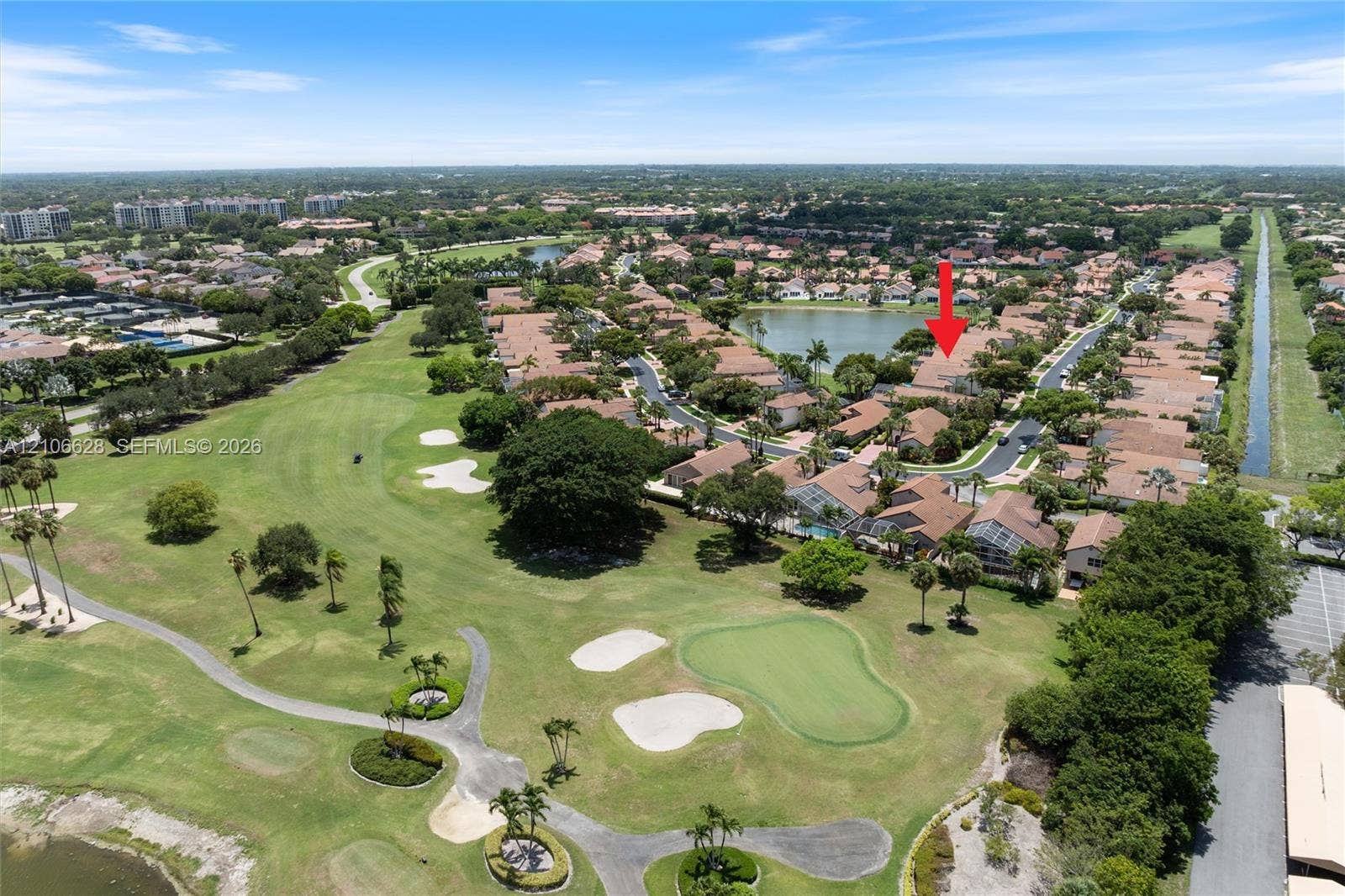 7259 Via Palomar, Boca Raton, FL 33433 Aerial perspective of a residential property featuring proximity to an expansive golf course, mature landscaping, and a nearby lake