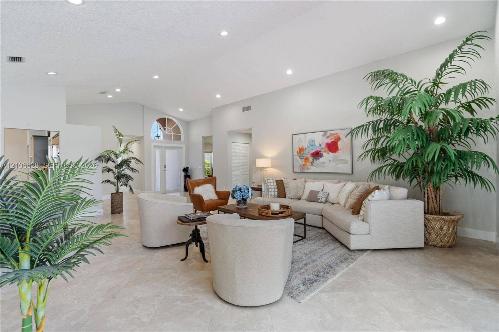 7259 Via Palomar, Boca Raton, FL 33433 Vaulted ceilings, neutral tile flooring, recessed lighting, and an arched transom window above the entrance door