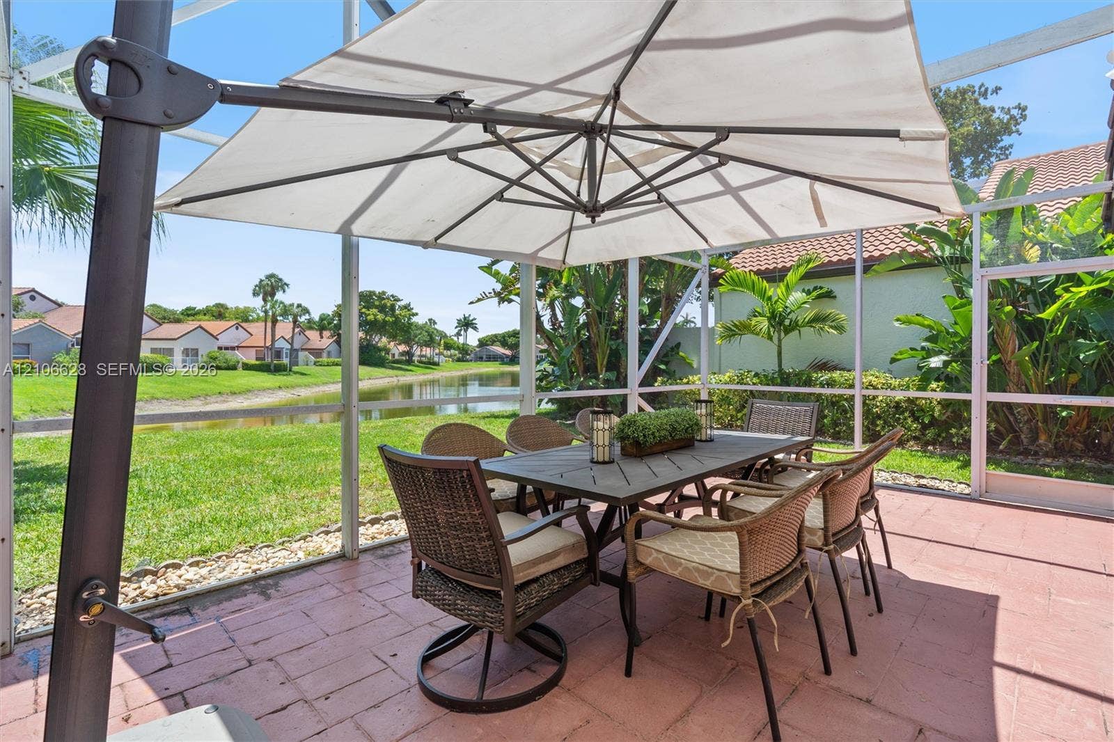 7259 Via Palomar, Boca Raton, FL 33433 Screen-enclosed patio featuring paver flooring and direct exposure to a water feature