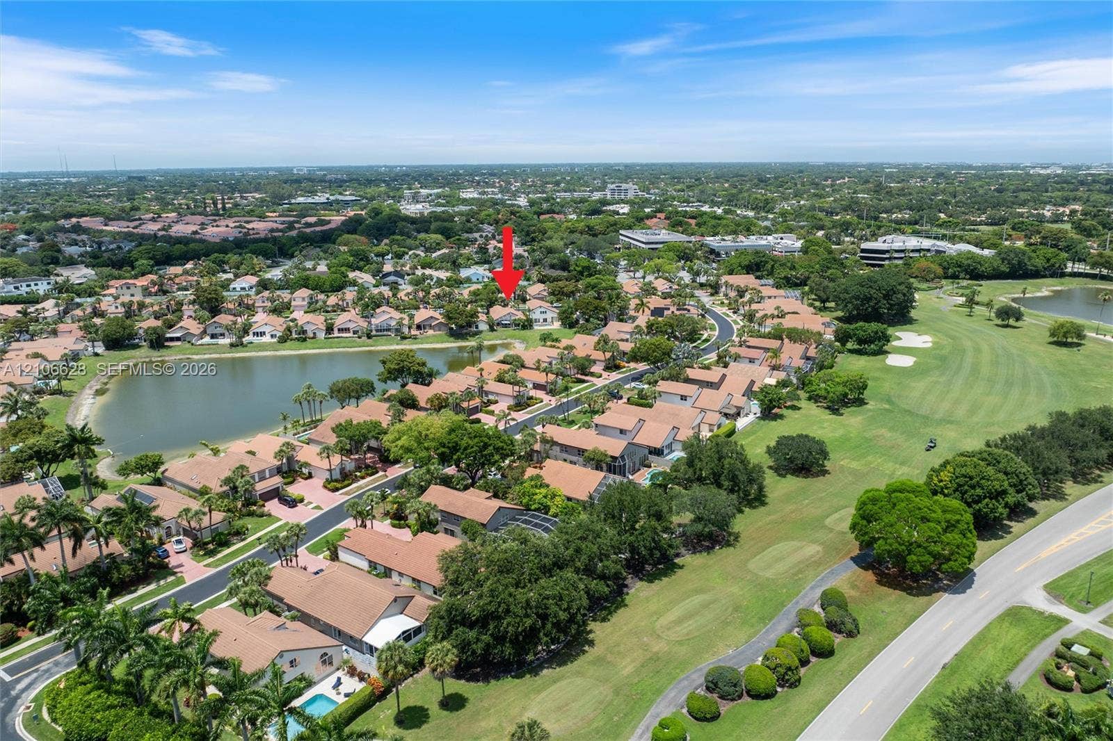 7259 Via Palomar, Boca Raton, FL 33433 Aerial perspective of residential property featuring tile roof construction, proximity to a lake, mature landscaping, and integration into a golf course community