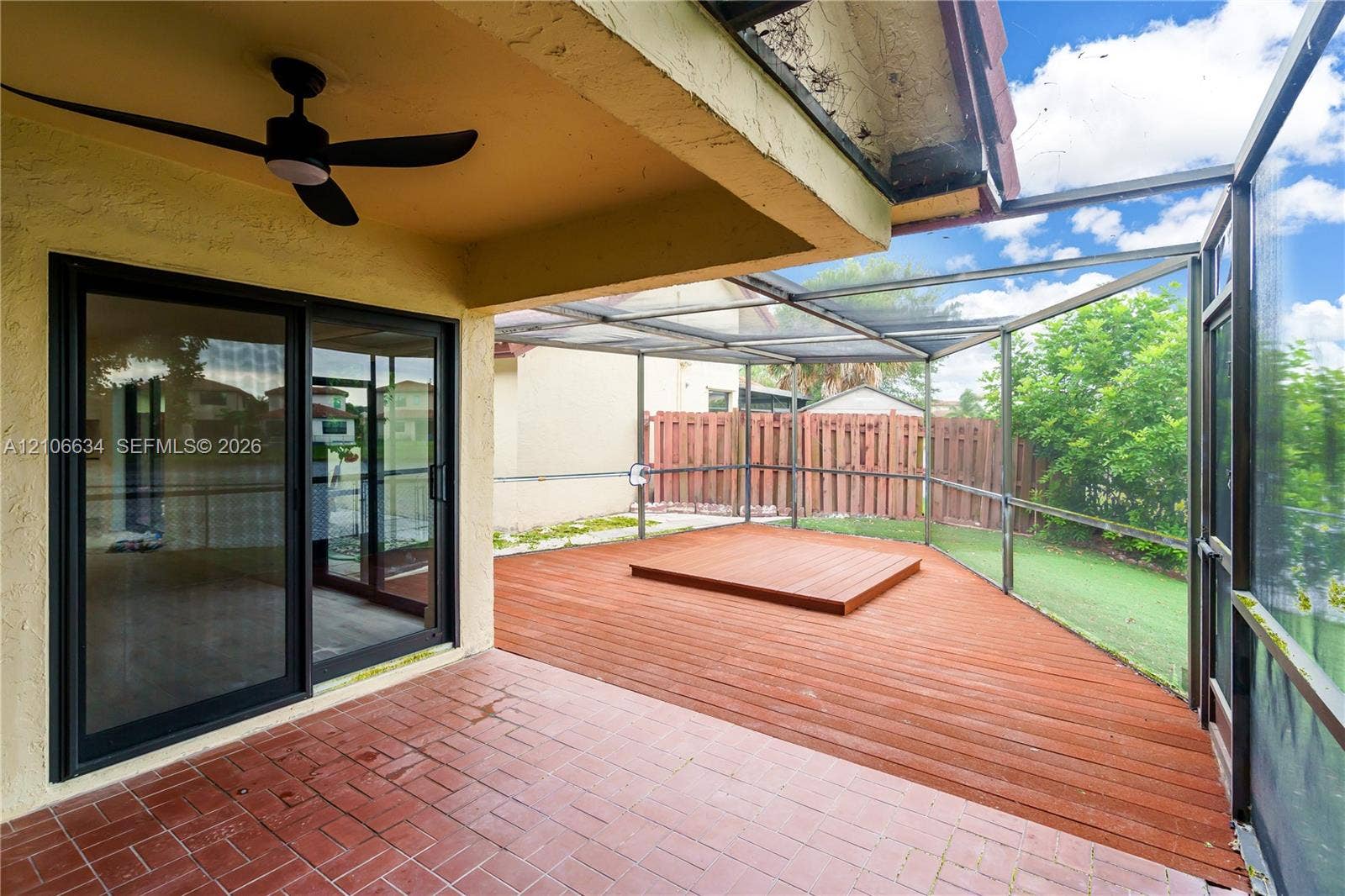 Screened-in outdoor living space with fan/light