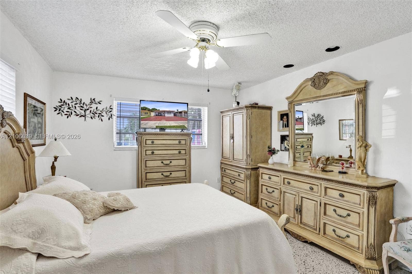 White interior with a multi-blade ceiling fan featuring integrated lighting, recessed ceiling lights, and horizontal-slat window blinds