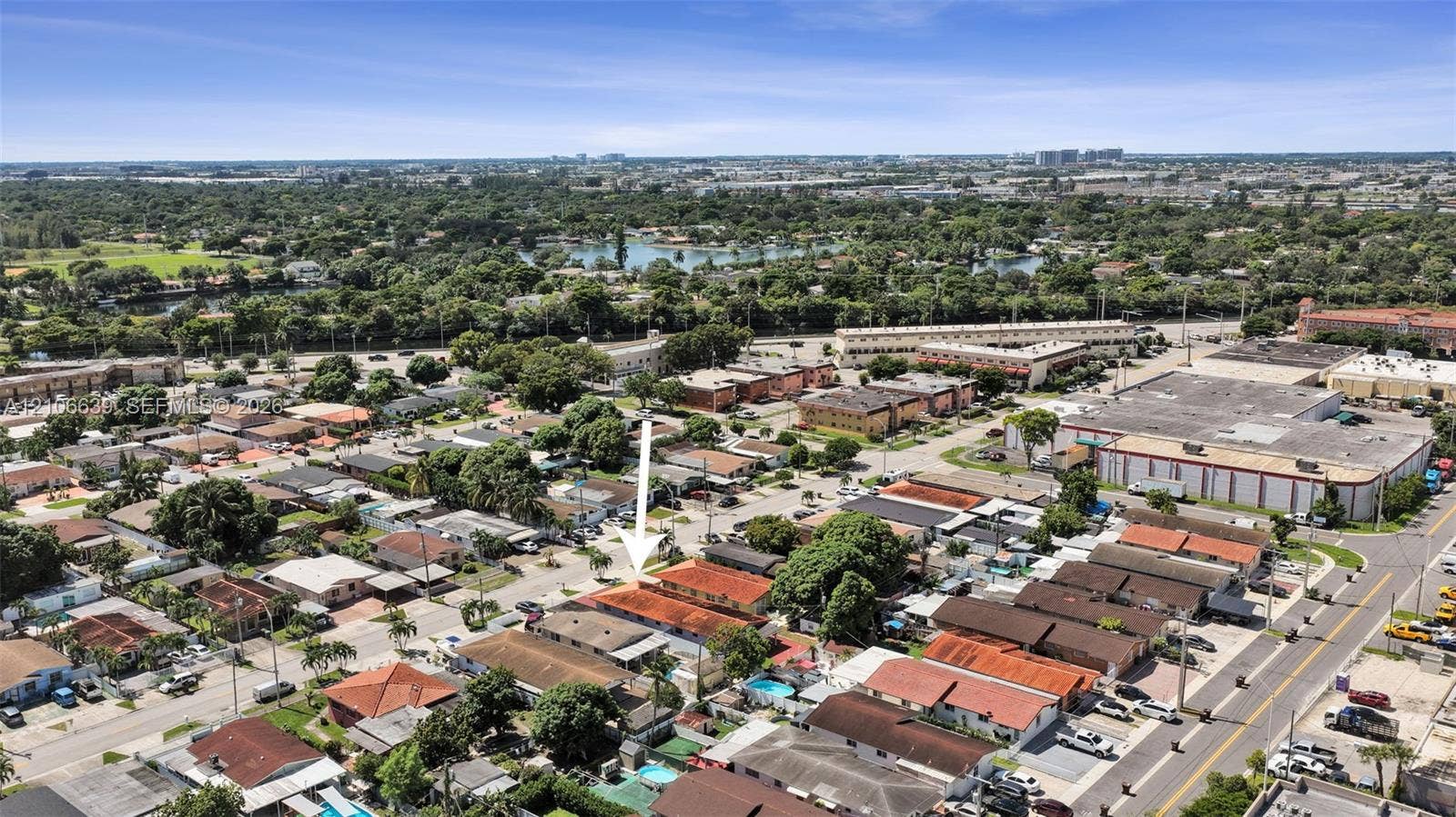 Aerial perspective featuring a single-story structure with a tile roof and dedicated surface parking