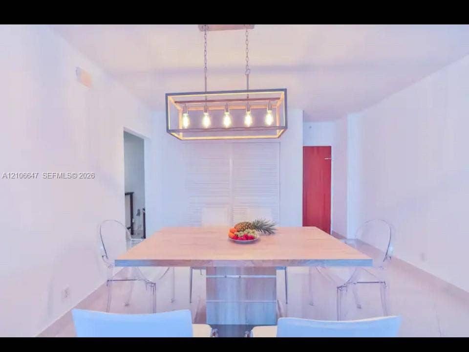 Rectangular linear chandelier with a metal frame, louvered closet doors, and smooth tile flooring