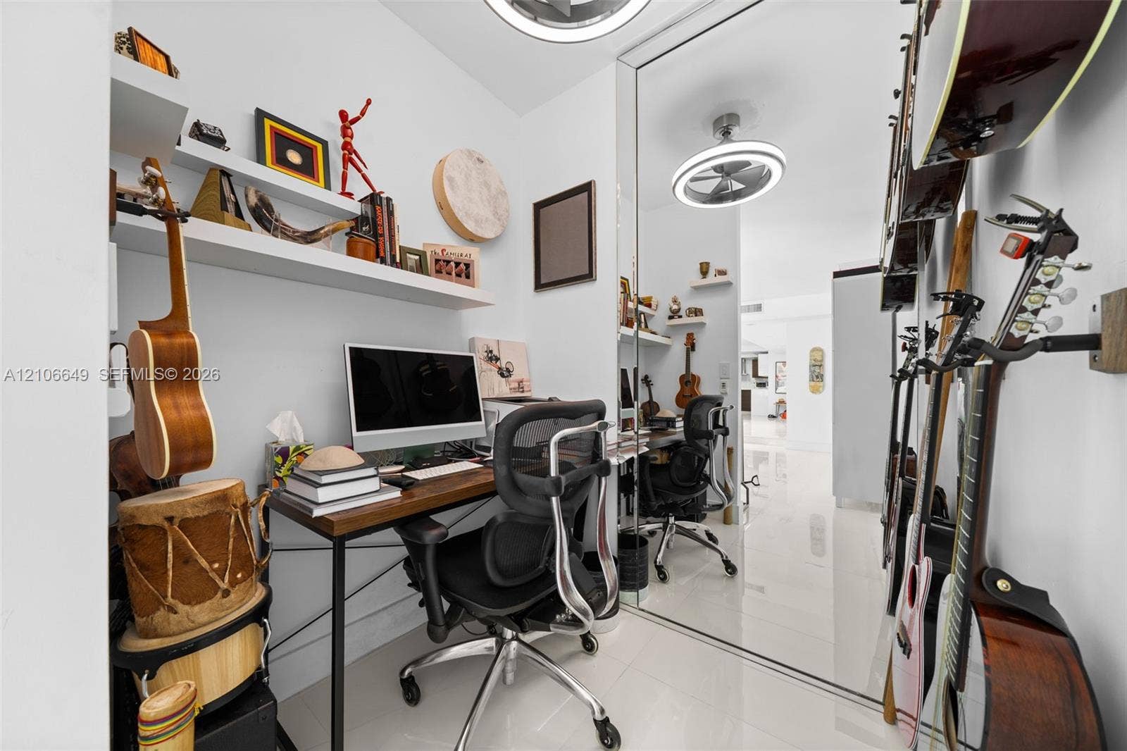 216 Poinciana Drive, #206, Sunny Isles Beach, FL 33160 Polished tile flooring, built-in wall-mounted shelving, floor-to-ceiling mirror paneling, and circular LED overhead lighting