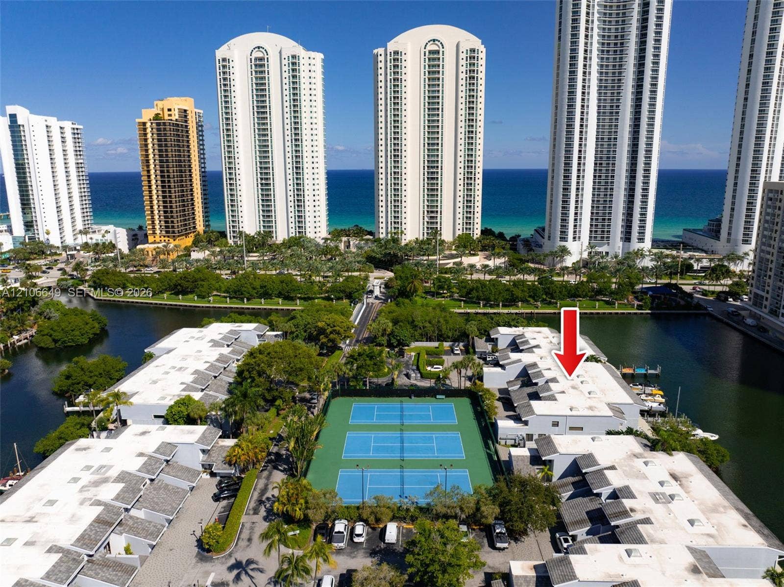 216 Poinciana Drive, #206, Sunny Isles Beach, FL 33160 Waterfront residential community featuring three hard-surface tennis courts and immediate canal access