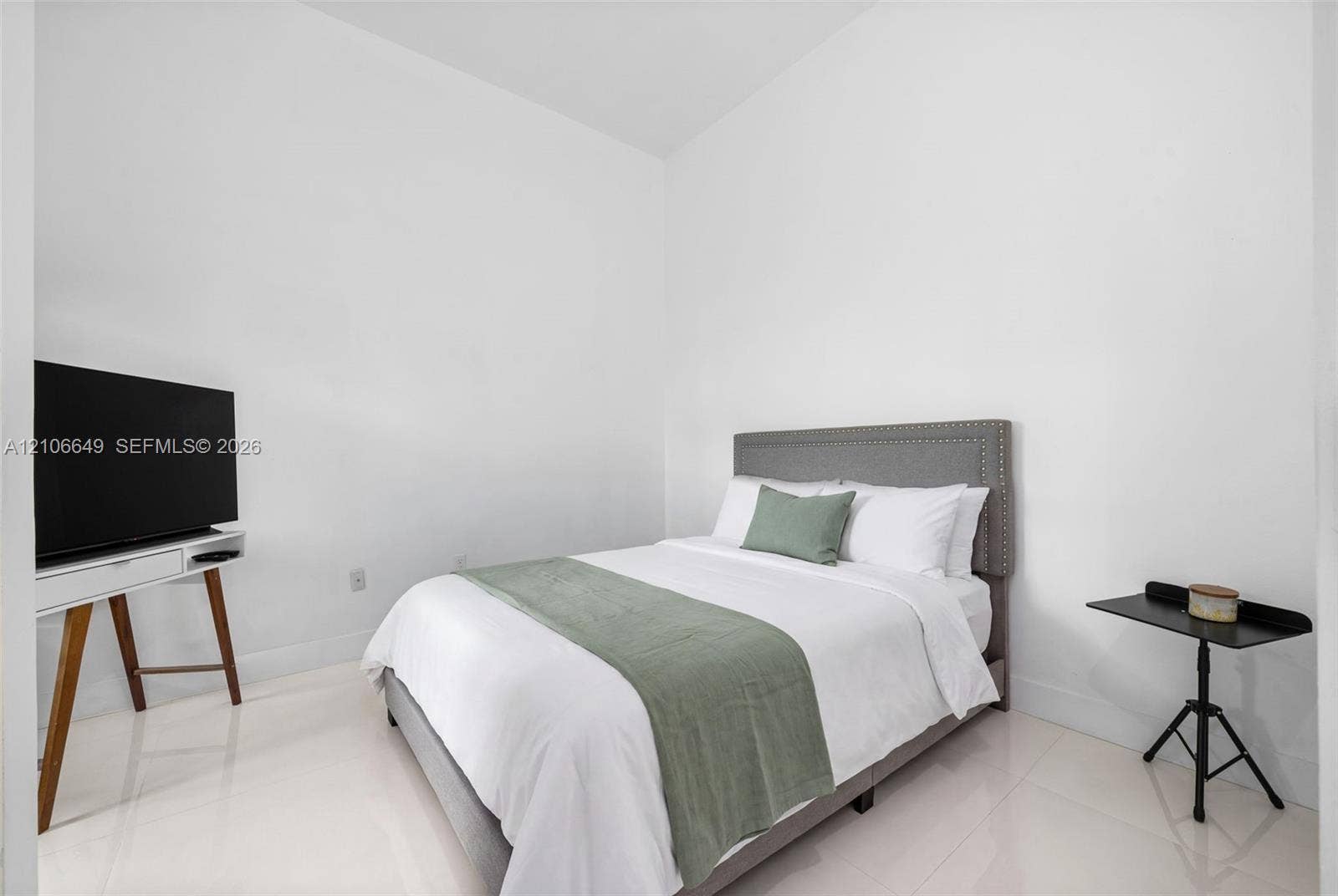 216 Poinciana Drive, #206, Sunny Isles Beach, FL 33160 High-ceilinged room featuring neutral white walls and polished porcelain flooring