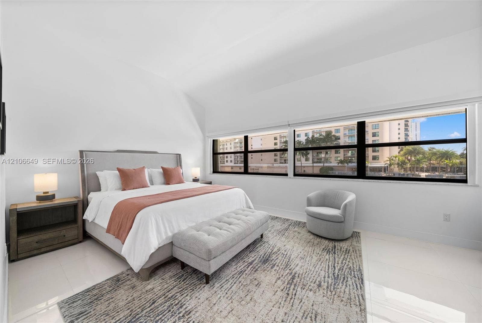 216 Poinciana Drive, #206, Sunny Isles Beach, FL 33160 Spacious interior with high vaulted ceilings, large expansive window configuration, and polished tile flooring