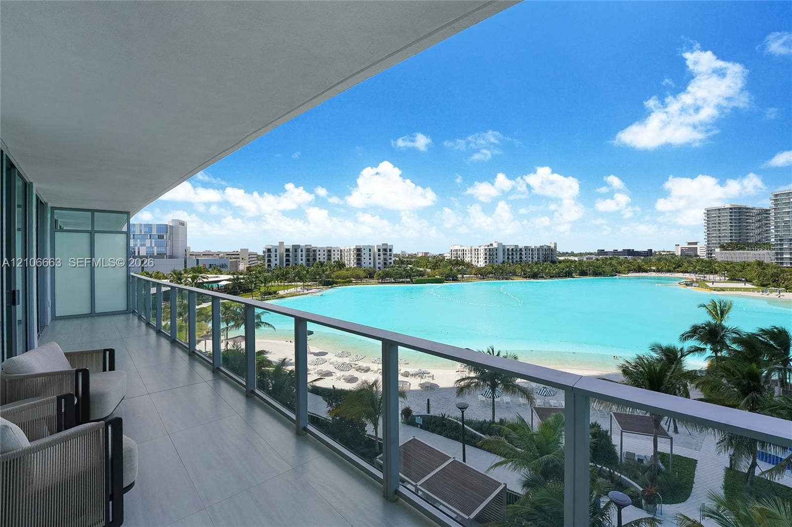 Covered balcony featuring oversized tile flooring and a glass panel railing