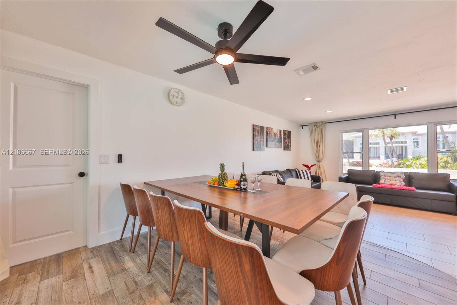 209 Bayshore Drive, Cape Coral, FL 33904 Wood-finish tile flooring, recessed lighting, and a modern black matte ceiling fan with integrated illumination