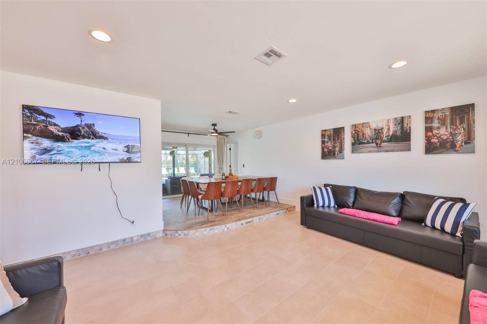 209 Bayshore Drive, Cape Coral, FL 33904 Open-concept interior featuring light-toned tile flooring, recessed ceiling lighting, and a multi-level floor plan with a raised dining platform