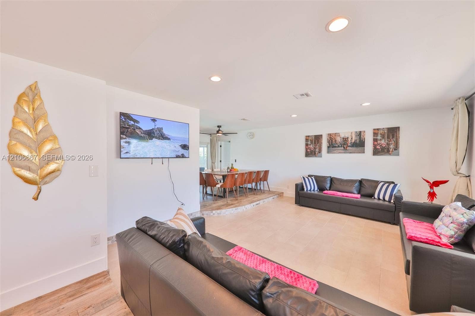 209 Bayshore Drive, Cape Coral, FL 33904 Open-concept living space featuring recessed lighting, ceramic tile flooring, and a raised platform area