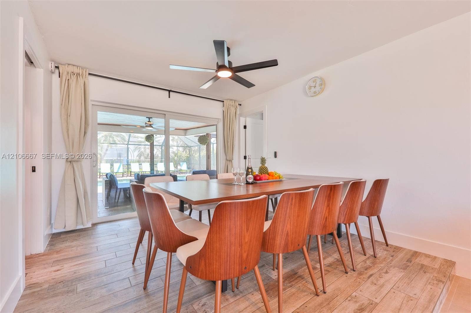 209 Bayshore Drive, Cape Coral, FL 33904 Dining area featuring wood-finish tile flooring, ceiling fan with integrated lighting, and sliding glass doors