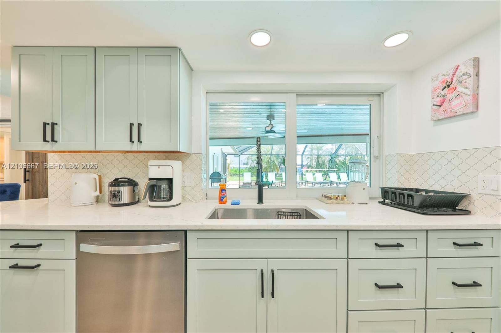 209 Bayshore Drive, Cape Coral, FL 33904 Kitchen featuring soft-green cabinetry, white countertops, recessed lighting, a stainless steel dishwasher, and a diamond-patterned backsplash