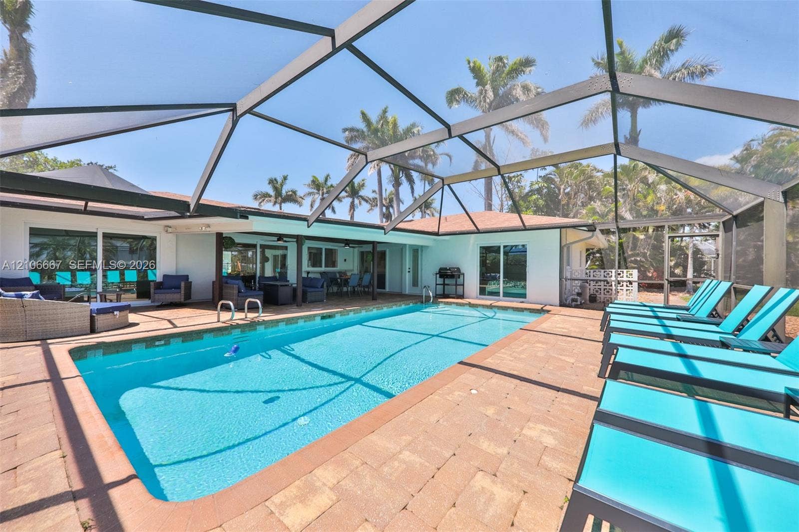 209 Bayshore Drive, Cape Coral, FL 33904 Screen-enclosed swimming pool with a paver patio and covered lanai