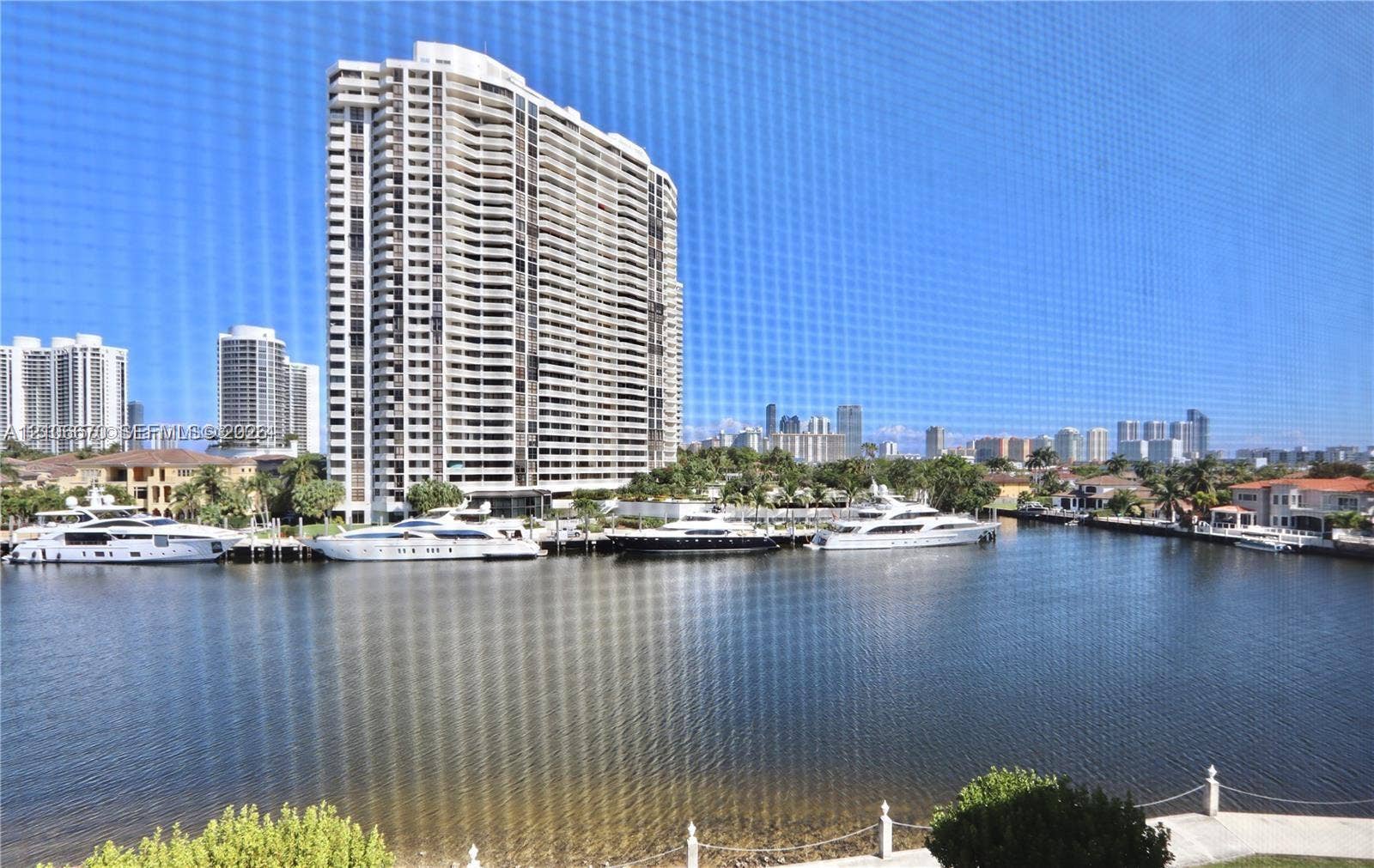 3030 Marcos Drive, #T512, Aventura, FL 33160 Waterfront setting featuring a concrete bulkhead, deep-water canal, and anchored recreational vessels