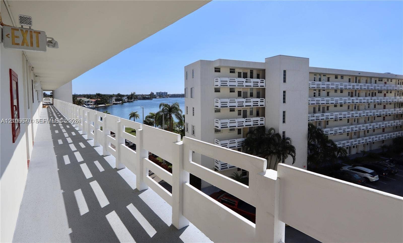3030 Marcos Drive, #T512, Aventura, FL 33160 Covered exterior walkway with white metal railing and a waterfront outlook