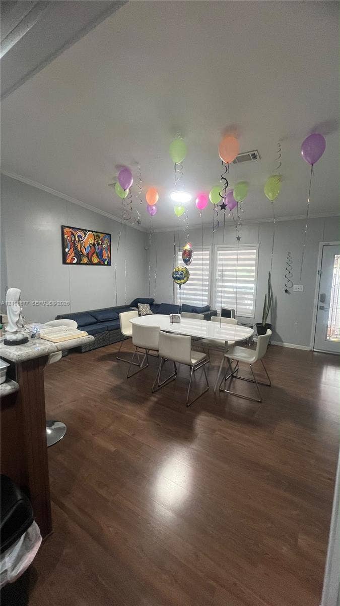 Open-concept interior featuring wood-finish flooring, recessed lighting, and windows equipped with horizontal blinds