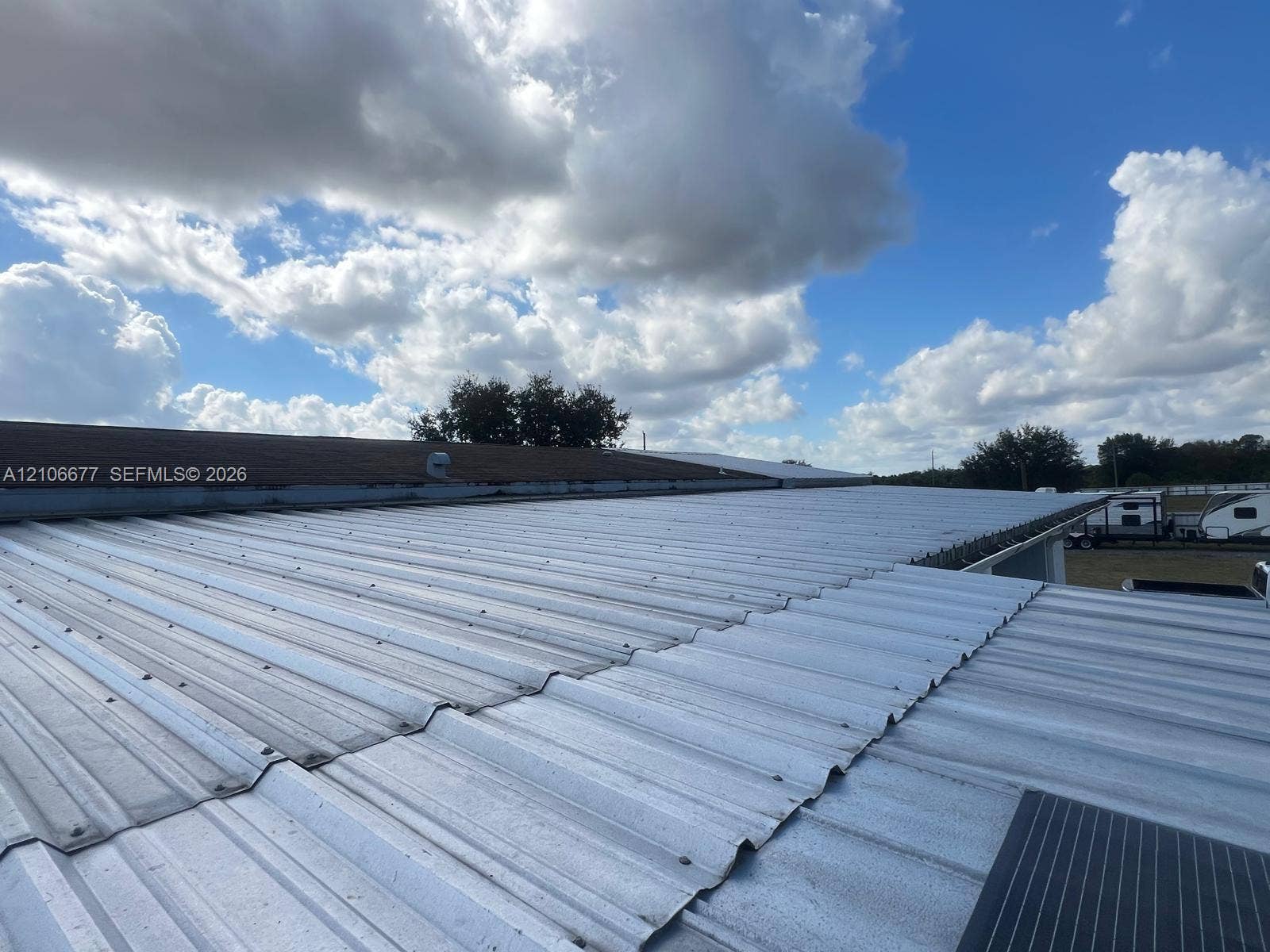 Corrugated metal roofing featuring a low-pitch design and integrated solar paneling