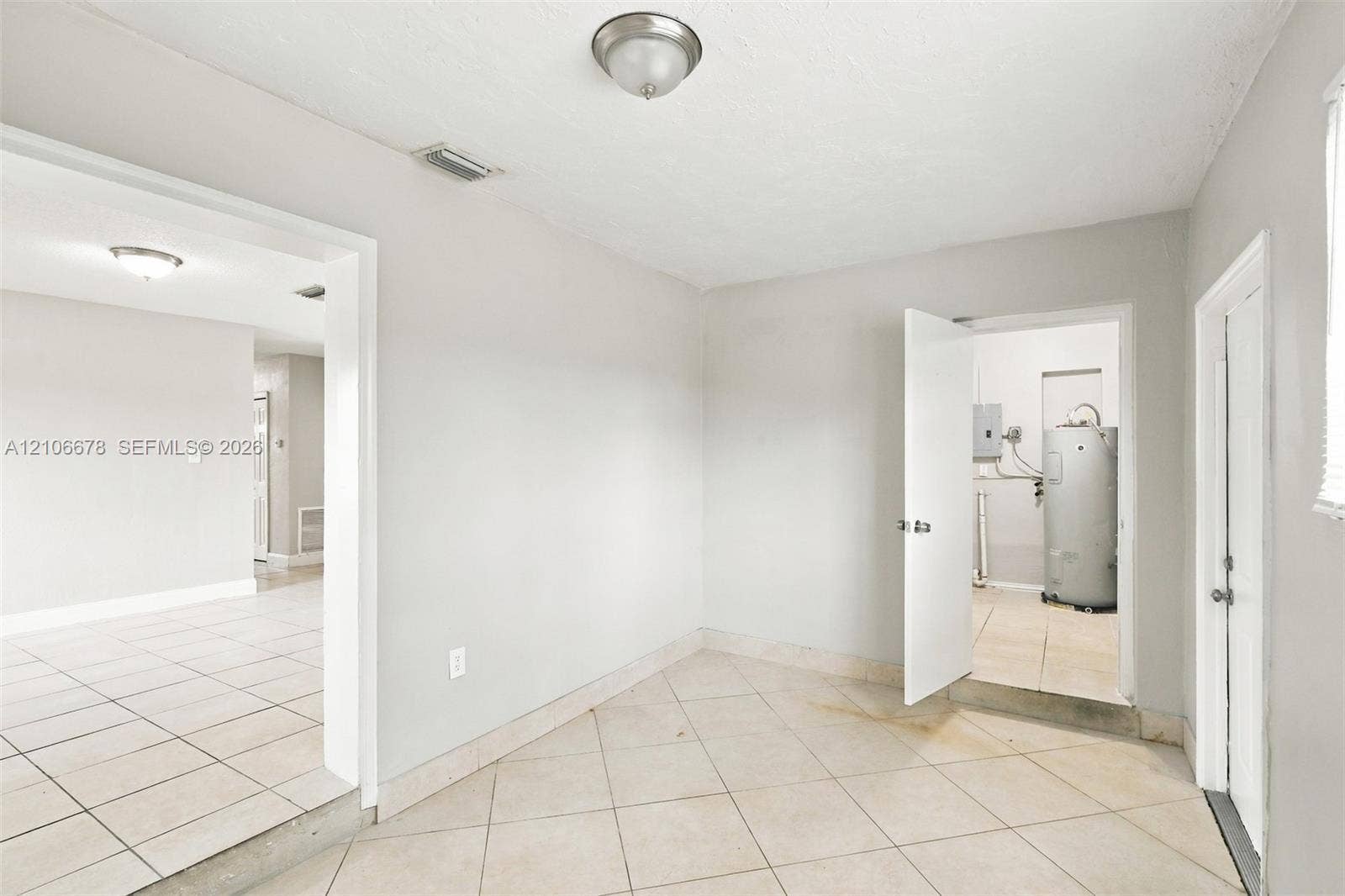 7060 Hood Street, Hollywood, Hollywood, FL 33024 Interior space featuring neutral wall paint, tile flooring laid on a diagonal pattern, and flush-mount ceiling light fixtures