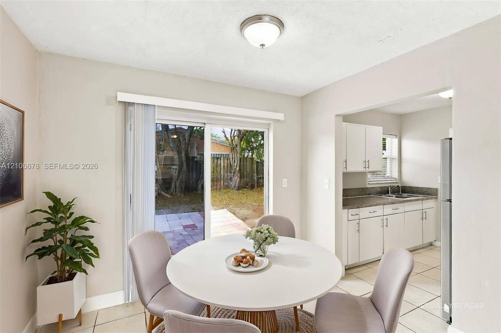 7060 Hood Street, Hollywood, Hollywood, FL 33024 Sliding glass door, tiled flooring, white cabinetry, stone-finish countertops, and flush-mount ceiling lighting