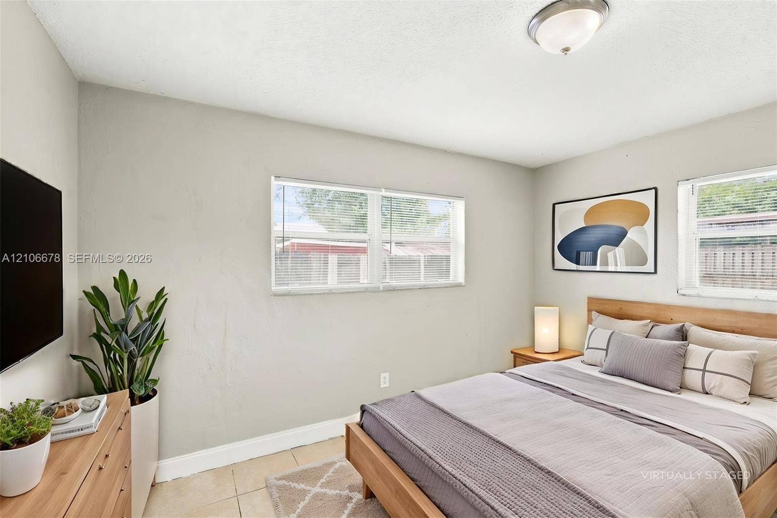 Neutral wall finish, dual windows with blinds, and tiled flooring