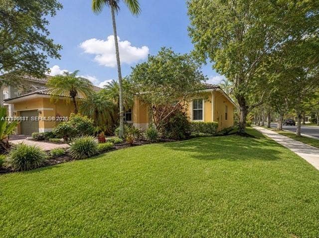 1213 Skylark Drive, #1213, Weston, Weston, FL 33327 Single-story exterior featuring a tile roof, paved driveway, stucco facade, and mature landscaping